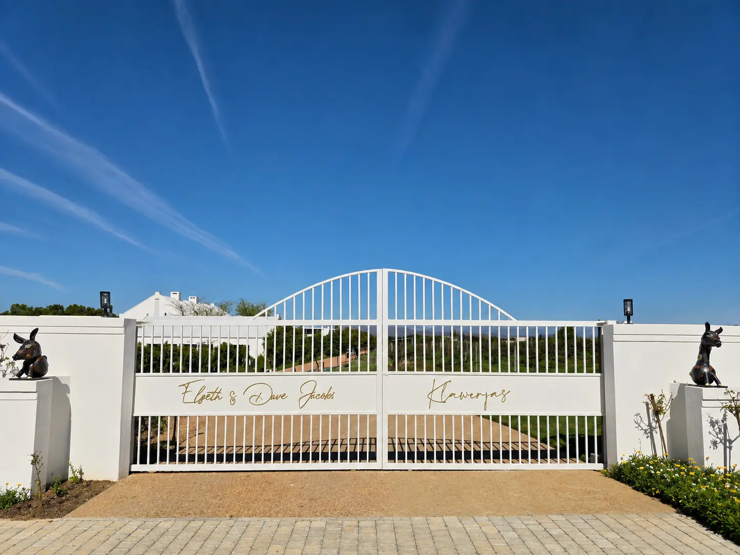 Klawerjas entrance gate with Elzeth Jacobs' Bumblebeast sculptures positioned as guardians on either side